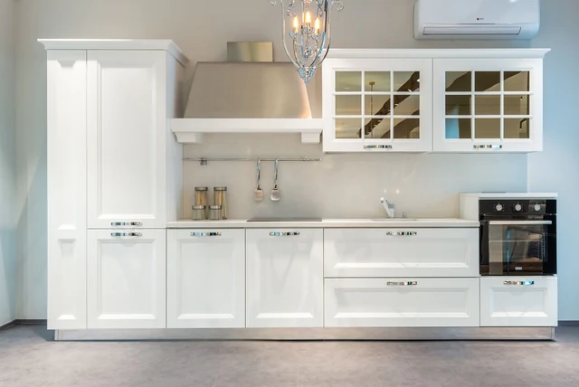 Ivory kitchen ideas UK with shaker cabinets and glass-fronted units