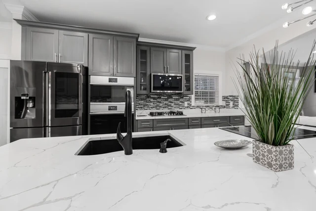 Quartz vs granite worktops UK compared on a white veined kitchen island