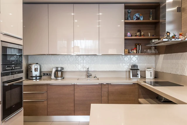 Taupe kitchen ideas UK with warm neutral units and open wood shelving