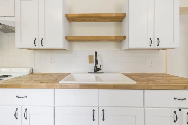 Solid wood worktops UK care shown on a timber worktop with a sink