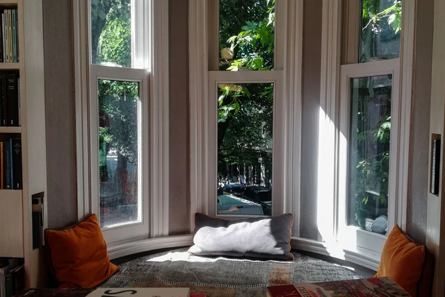 Window seat ideas with storage in a bright bay window
